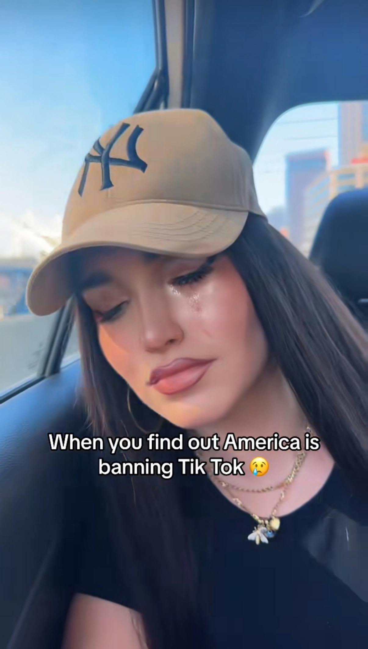 TikTok screenshot of a woman crying in the car. Text overlay reads, 'When you find out America is banning TikTok.'