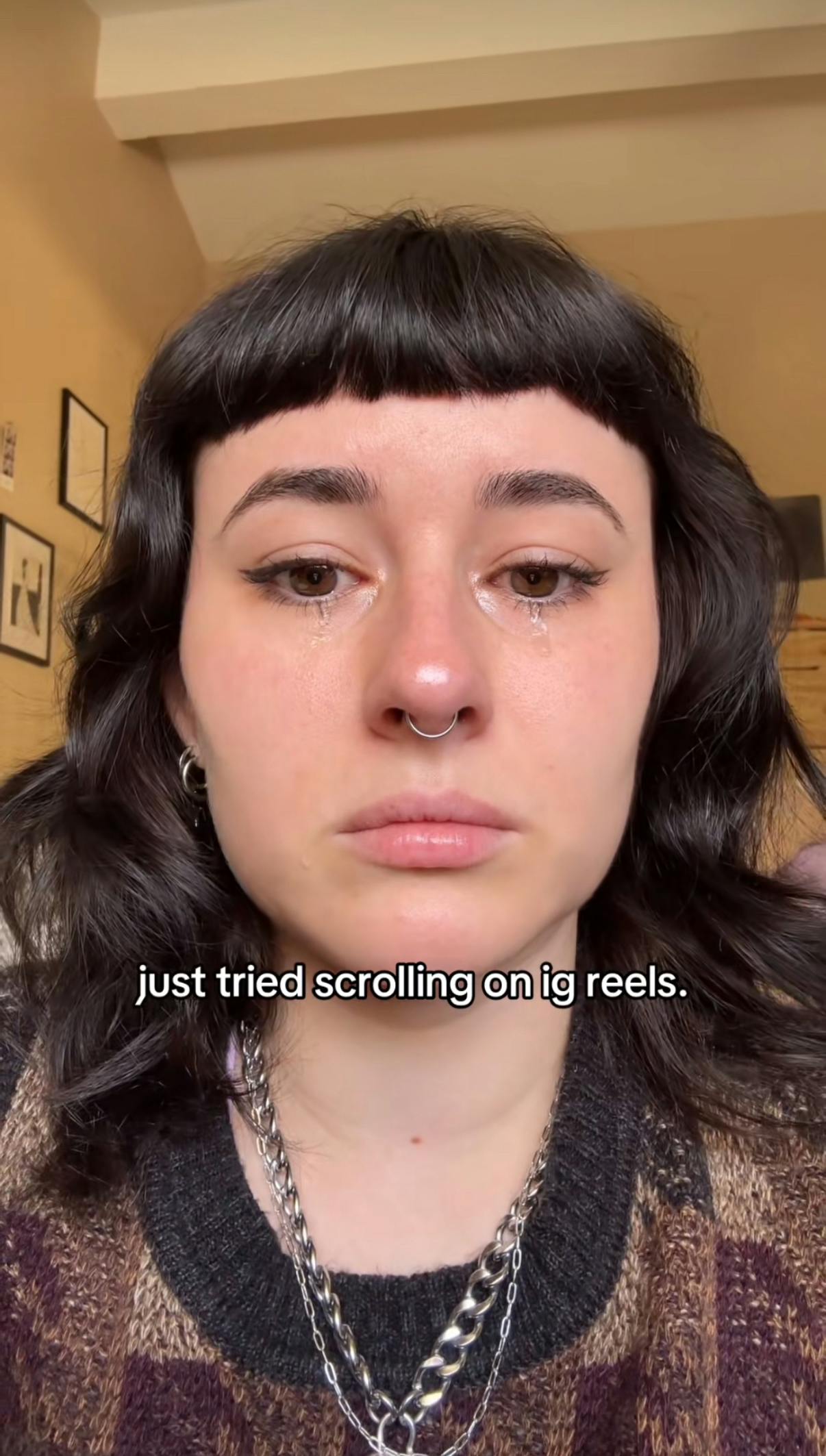 TikTok screenshot of a woman crying into the camera. Text overlay reads, 'just tried scrolling on ig reels.'