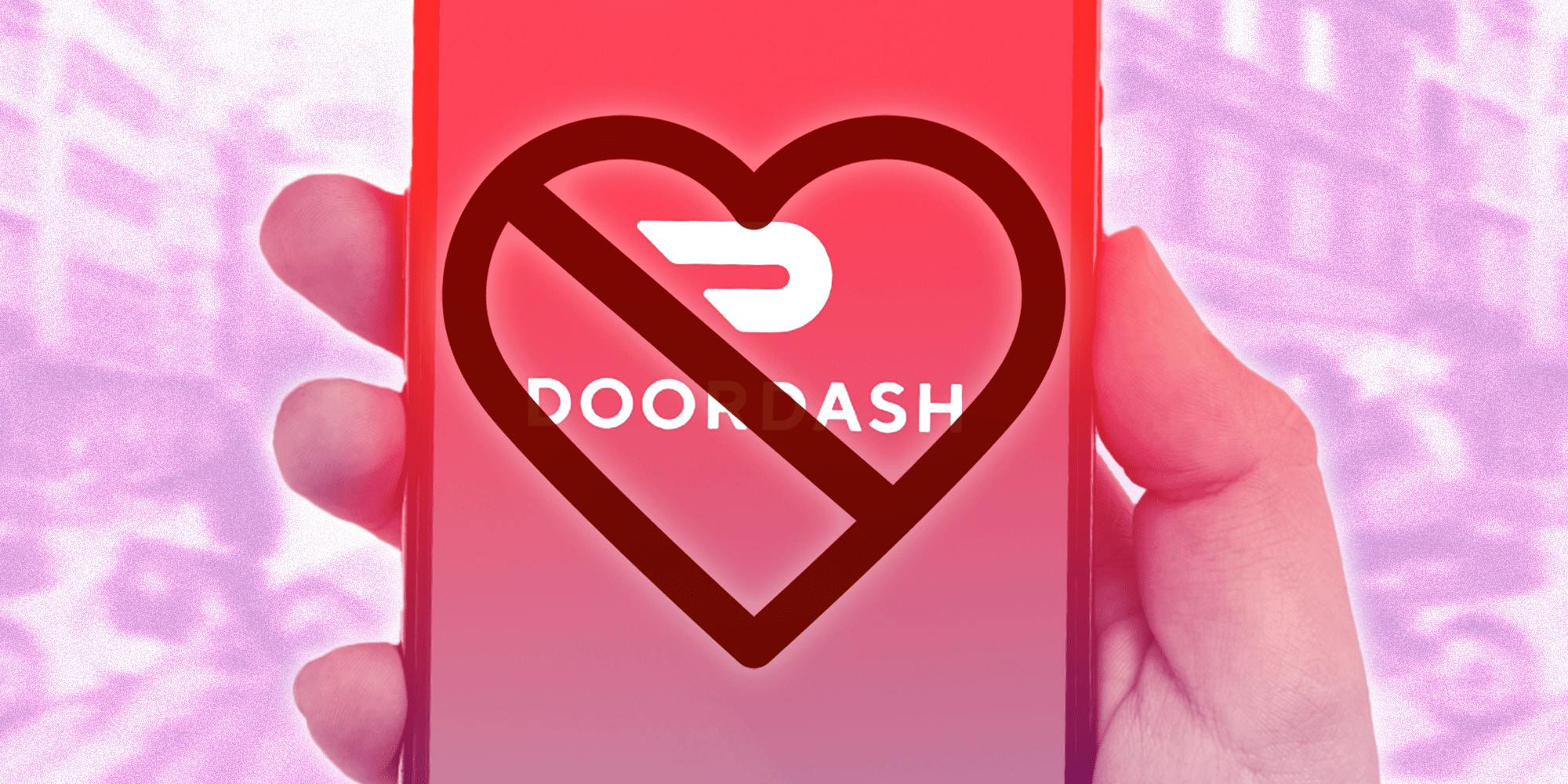 A hand holding a phone with the DoorDash app open with a heart-shaped cross out symbol covering the Doordash logo.