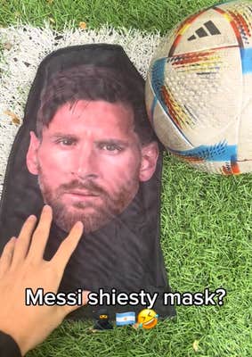 Lionel Messi face mask TikTok video showing someone reaching for the mask on a soccer field.