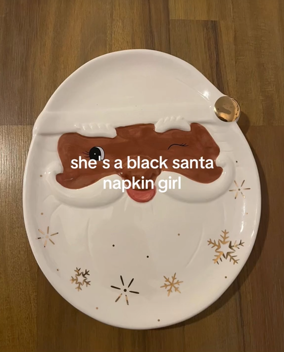 Black Santa Napkin meme TikTok video with a Black Santa plate and a caption reading 'she's a black santa napkin girl.'