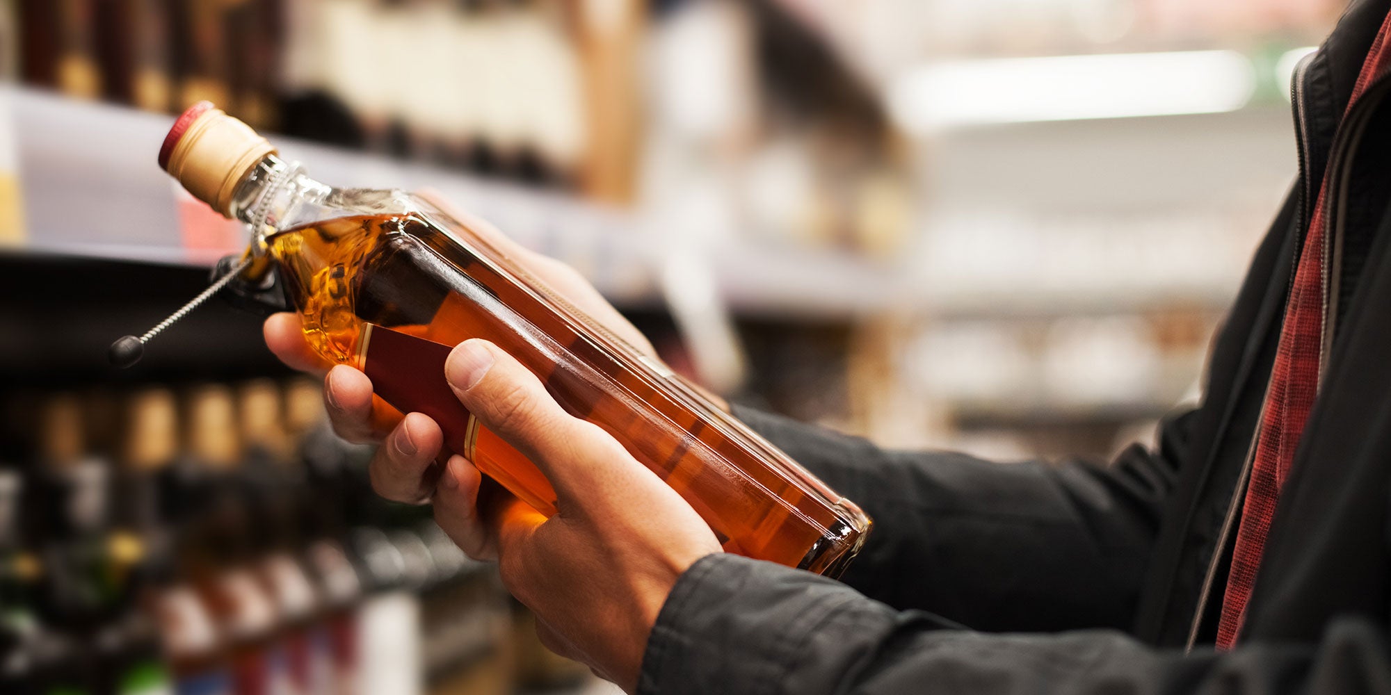 Customer holding bottle of liqour