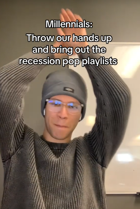 A man in a gray sweater with his hands in the air under the caption 'Millennials: Throw our hands up and bring out the recession pop playlists.'