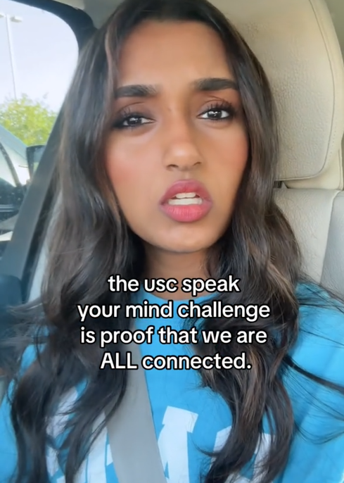 TikTok video of a woman singing to the camera with a caption reading 'the usc speak your mind challenge is proof that we are ALL connected.'