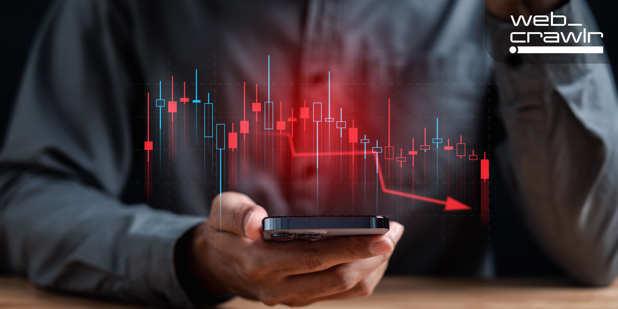 A person holding a phone with a display of a graph descending. The Daily Dot newsletter web_crawlr logo is in the top right corner.