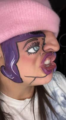 TikToker with a painted cartoon rendition of Katy Perry on the side of their face to lip-sync with the song.