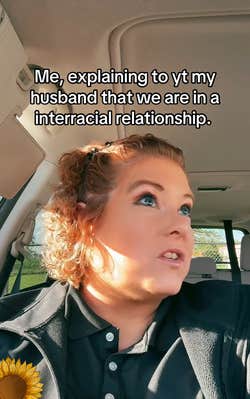 Redheaded woman in a car, text overlay reads, "Me, explaining to yt my husband that we are in a interracial relationship."