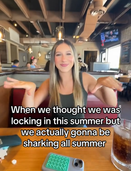 TikTok video with a woman dancing in a restaurant booth.