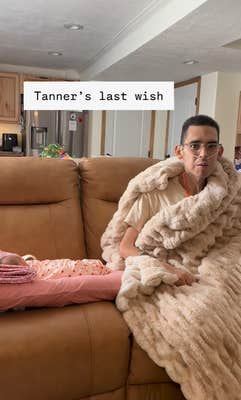 A terminally ill man wrapped in a plush blanket on the couch next to his newborn daughter. Text overlay reads, "Tanner's last wish."