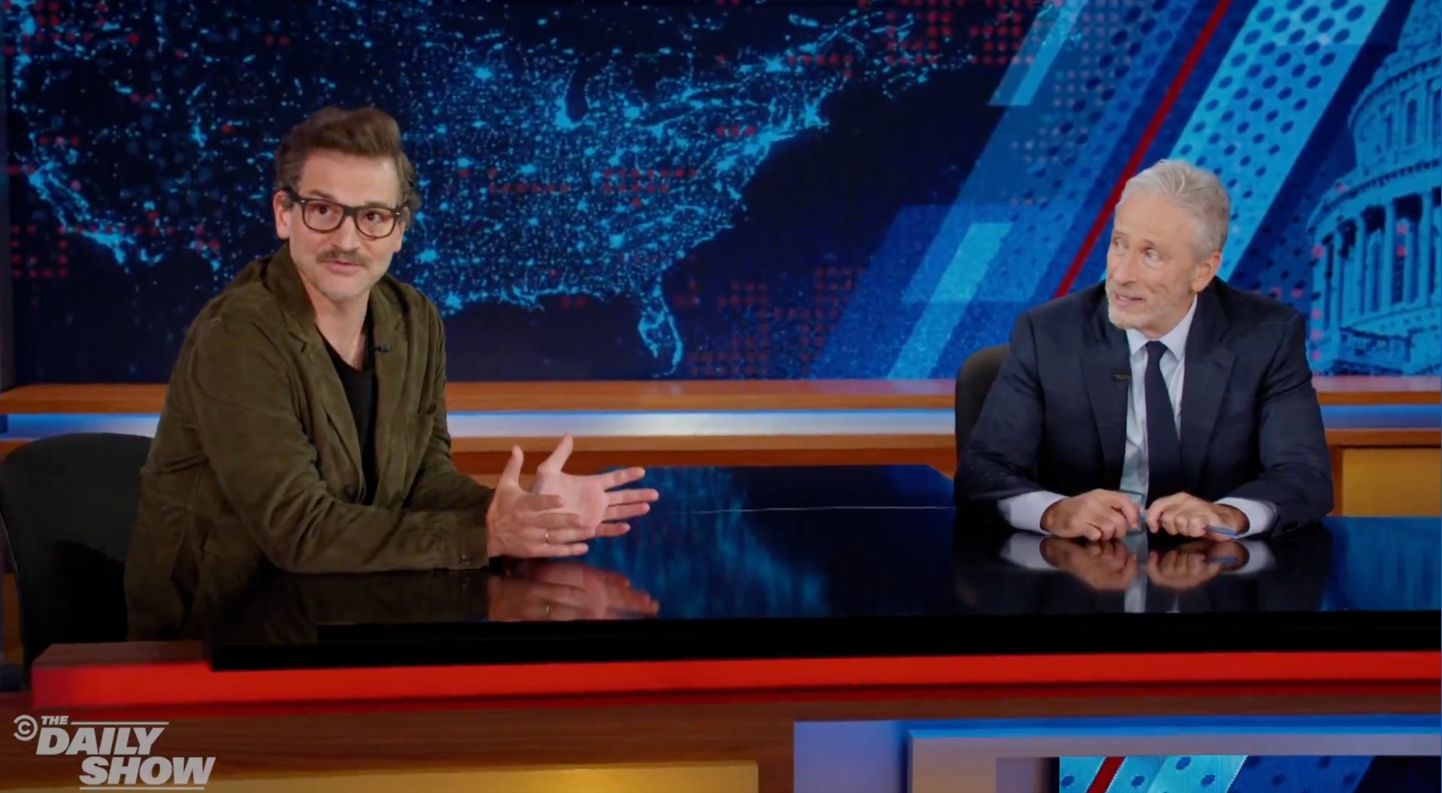 pedro pascal lookalike george talking to jon stewart on the daily show