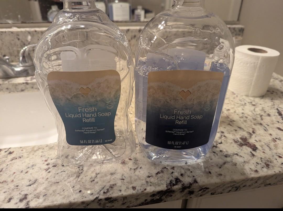 Two refill containers of 'fresh liquid hand soap.' One looks thinner but contains 56 FL oz while the one next to it contains 50 FL oz.