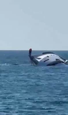$1 million yacht capsizing, presumably the owner standing on the side of the yacht.