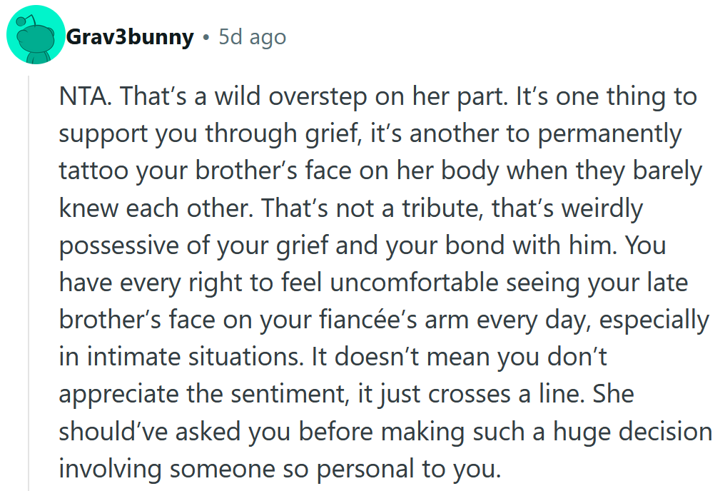 Reddit comment reading 'NTA. That’s a wild overstep on her part. It’s one thing to support you through grief, it’s another to permanently tattoo your brother’s face on her body when they barely knew each other. That’s not a tribute, that’s weirdly possessive of your grief and your bond with him. You have every right to feel uncomfortable seeing your late brother’s face on your fiancée’s arm every day, especially in intimate situations. It doesn’t mean you don’t appreciate the sentiment, it just crosses a line. She should’ve asked you before making such a huge decision involving someone so personal to you.'