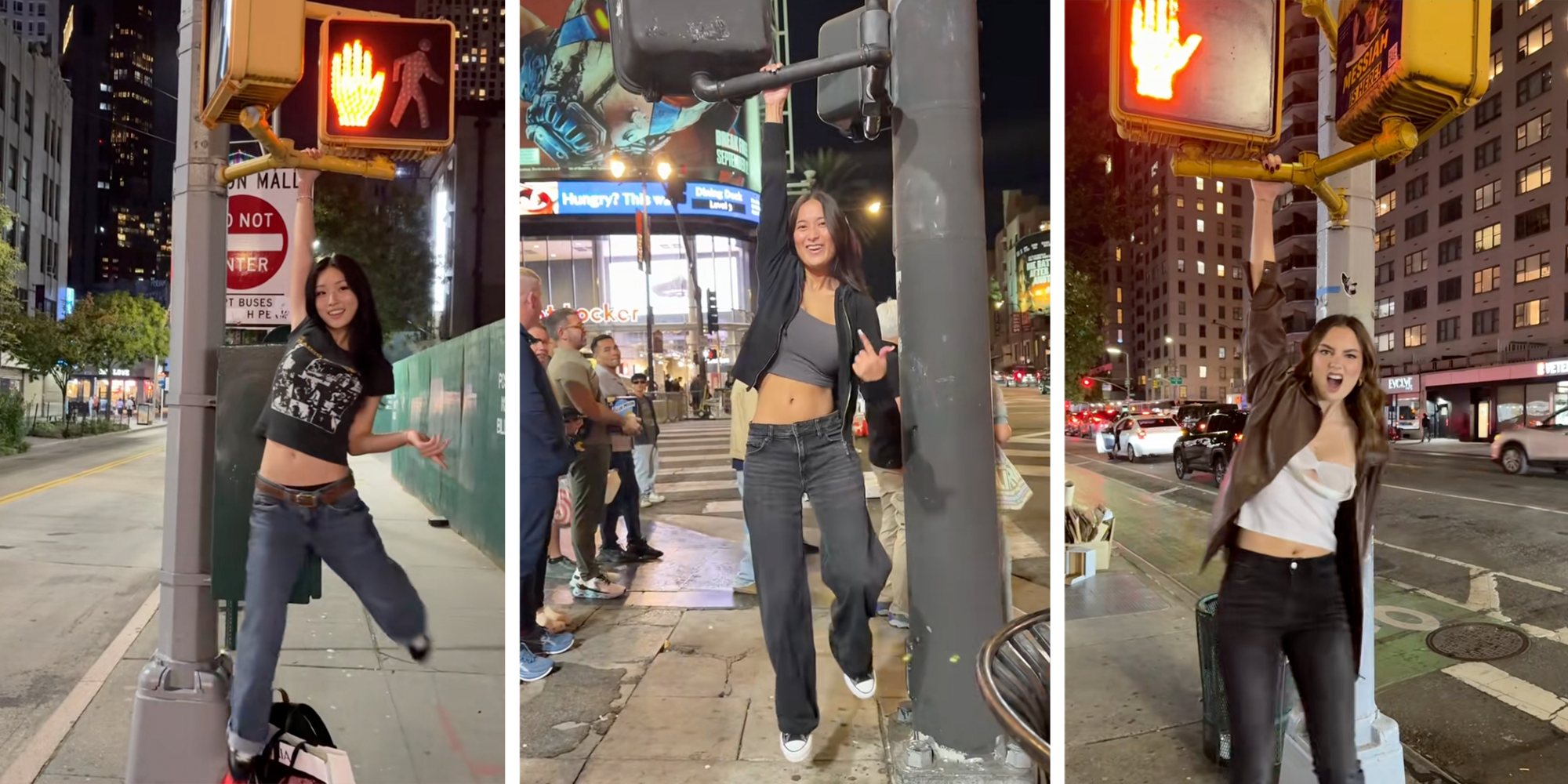 women hanging off of a crosswalk sign with one arm