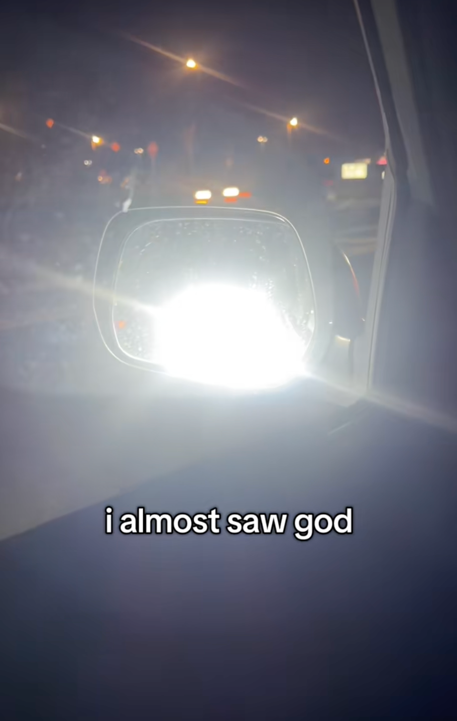 @alexamcnee/TikTok glare in side view mirror from bright headlights in traffic and onscreen text: i almost saw god