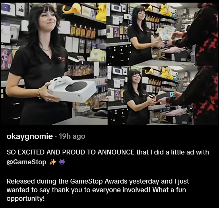 Screenshot of a TikTok video with a goth girl (Best Buy Girl) accepting trades at GameStop with a smile for the customer. Text in the caption reads, "SO EXCITED AND PROUD TO ANNOUNCE that I did a little ad with @GameStop
Released during the GameStop Awards yesterday and 1 just wanted to say thank you to everyone involved! What a fun opportunity!"