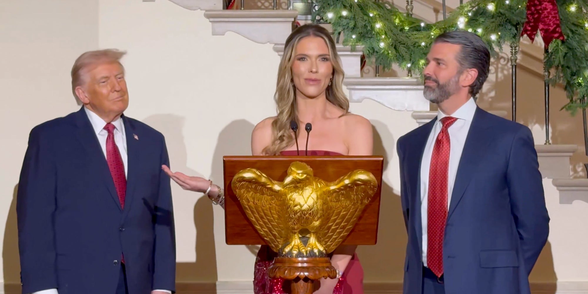 Bettina Anderson speaking at at an eagle dais at the White House while standing next to Donald Trump Jr. President Donald Trump stands to her right.