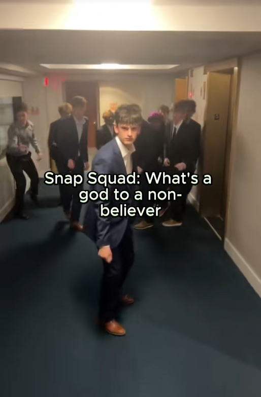 TikTok video of a group of young men doing the snap and step thing from Grease with a caption reading 'Snap Squad: What's a god to a non-believer'
