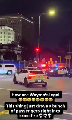 Waymo car driving through a police standoff at night. Text overlay reads, "How are Waymo's legal. This thing just drove a bunch of passengers right into crossfire."