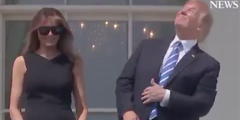 trump looks at eclipse