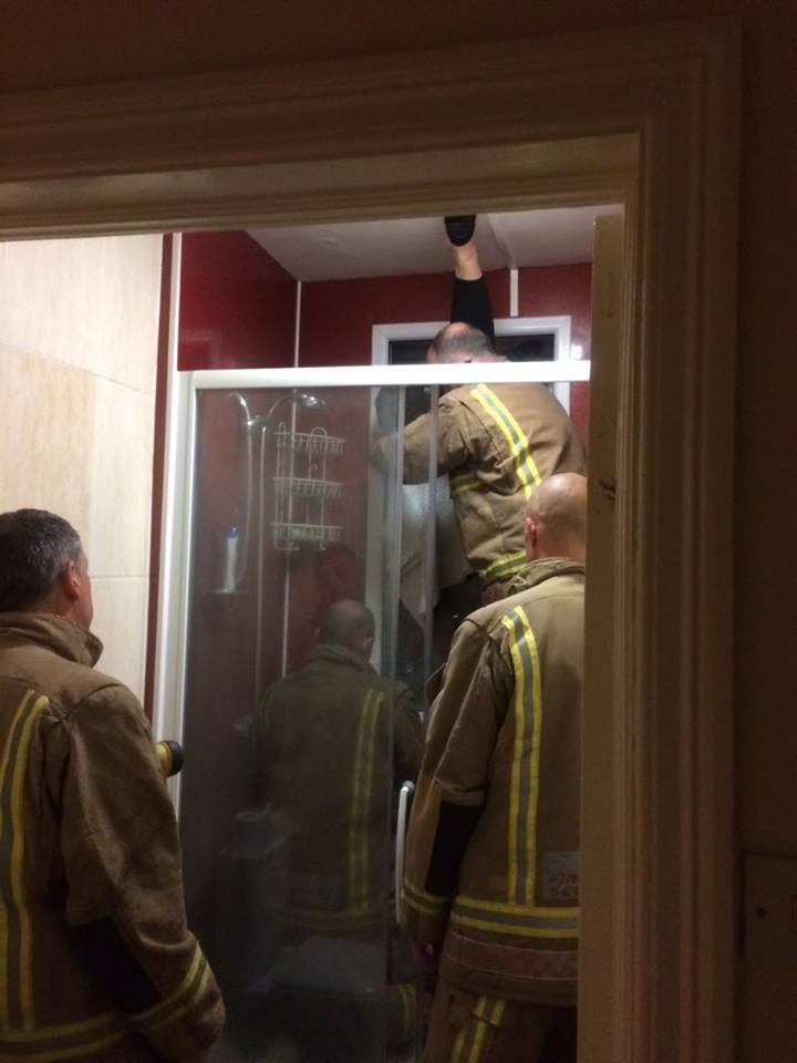 A firefighter crew rescues Liam Smyth's Tinder date from two windows she became trapped between while retrieving a poop she tried to throw away.