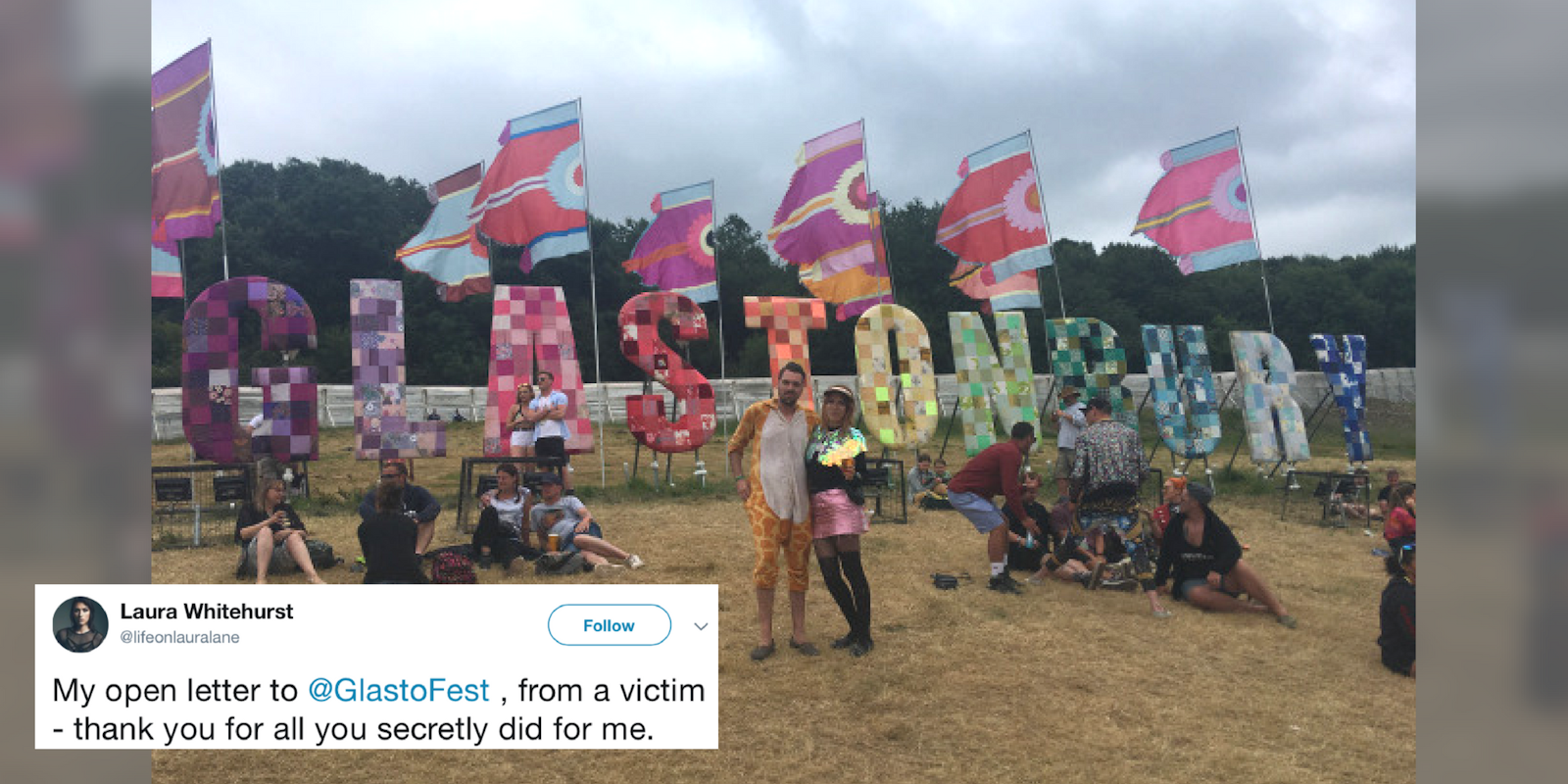 Glastonbury attendees in front of the 'Glastonbury' letter art piece