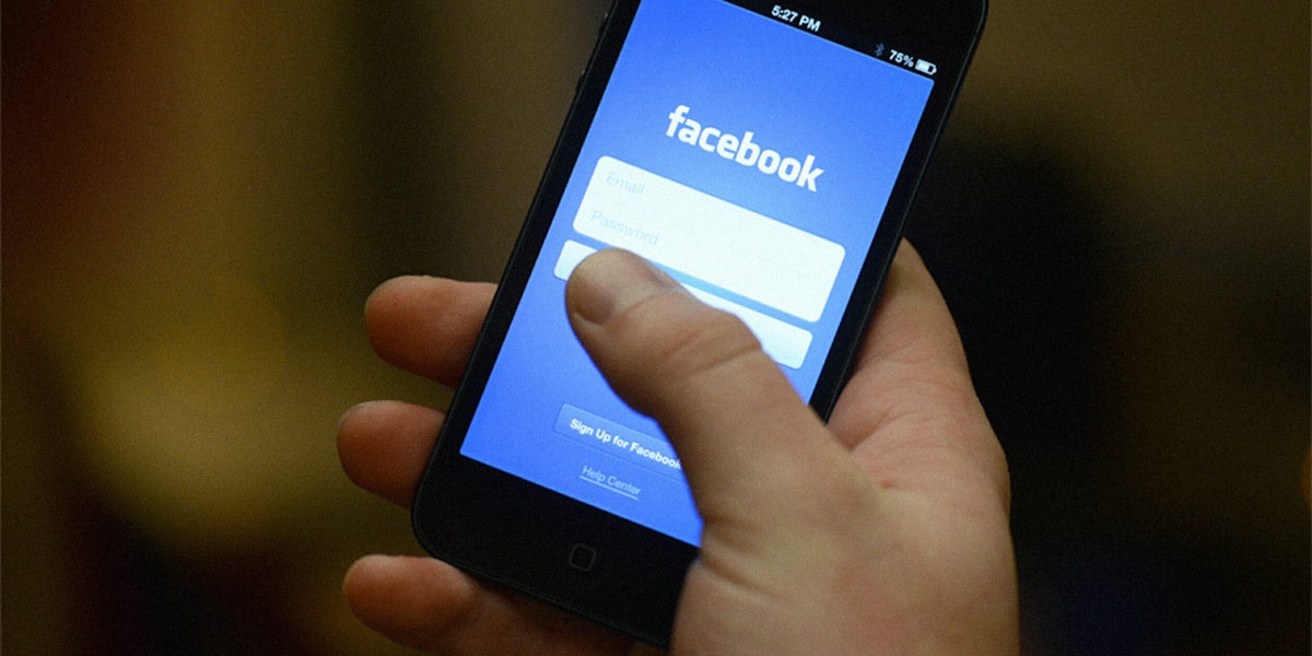 Hand opening Facebook mobile app