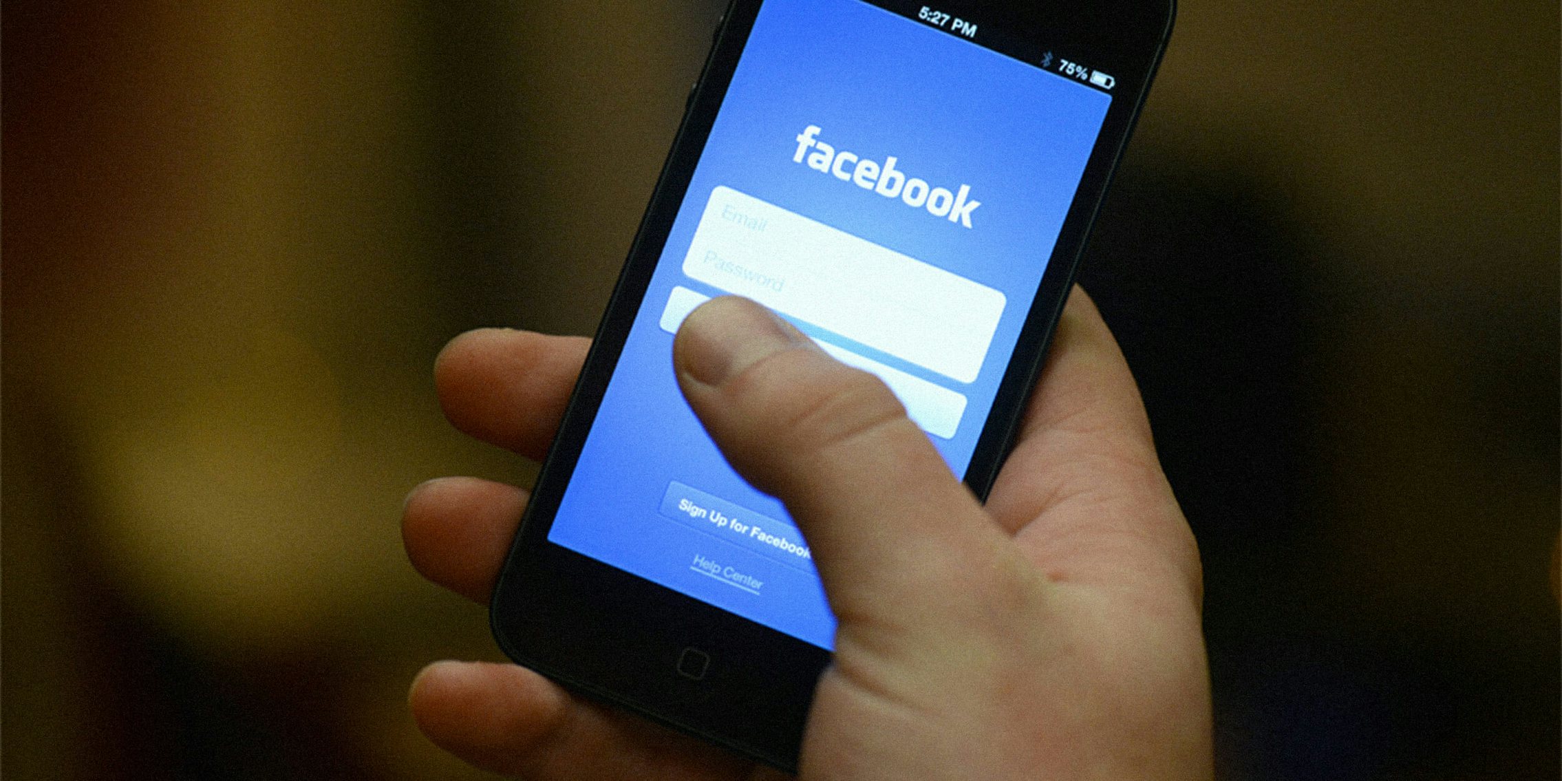 Hand opening Facebook mobile app