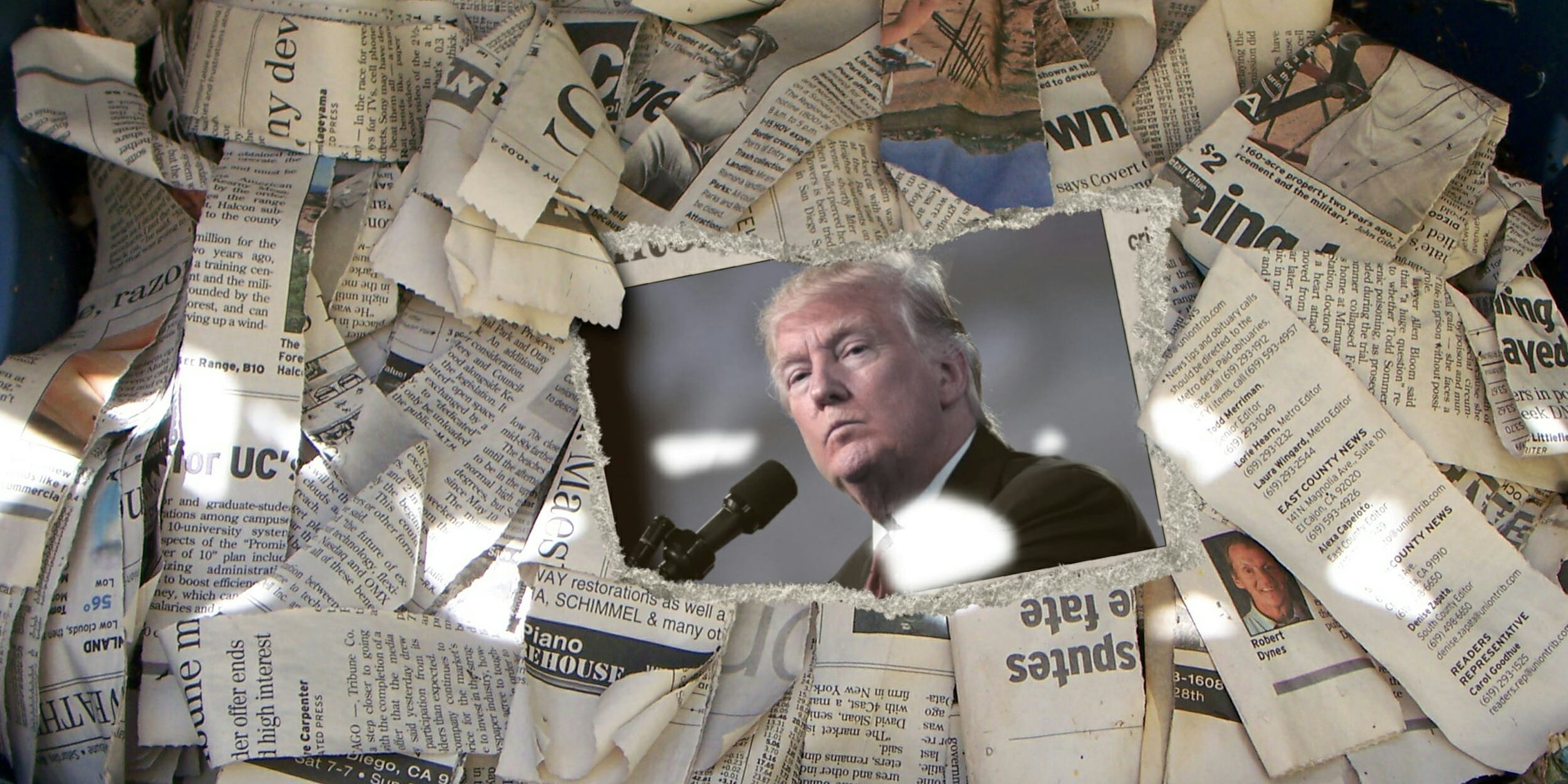 Donald Trump, surrounded by newspapers. His anti-press rhetoric is concerning to experts.