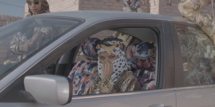 A shot from MIA's music video for 'Bad Girls' with a woman sitting behind the wheel of a car
