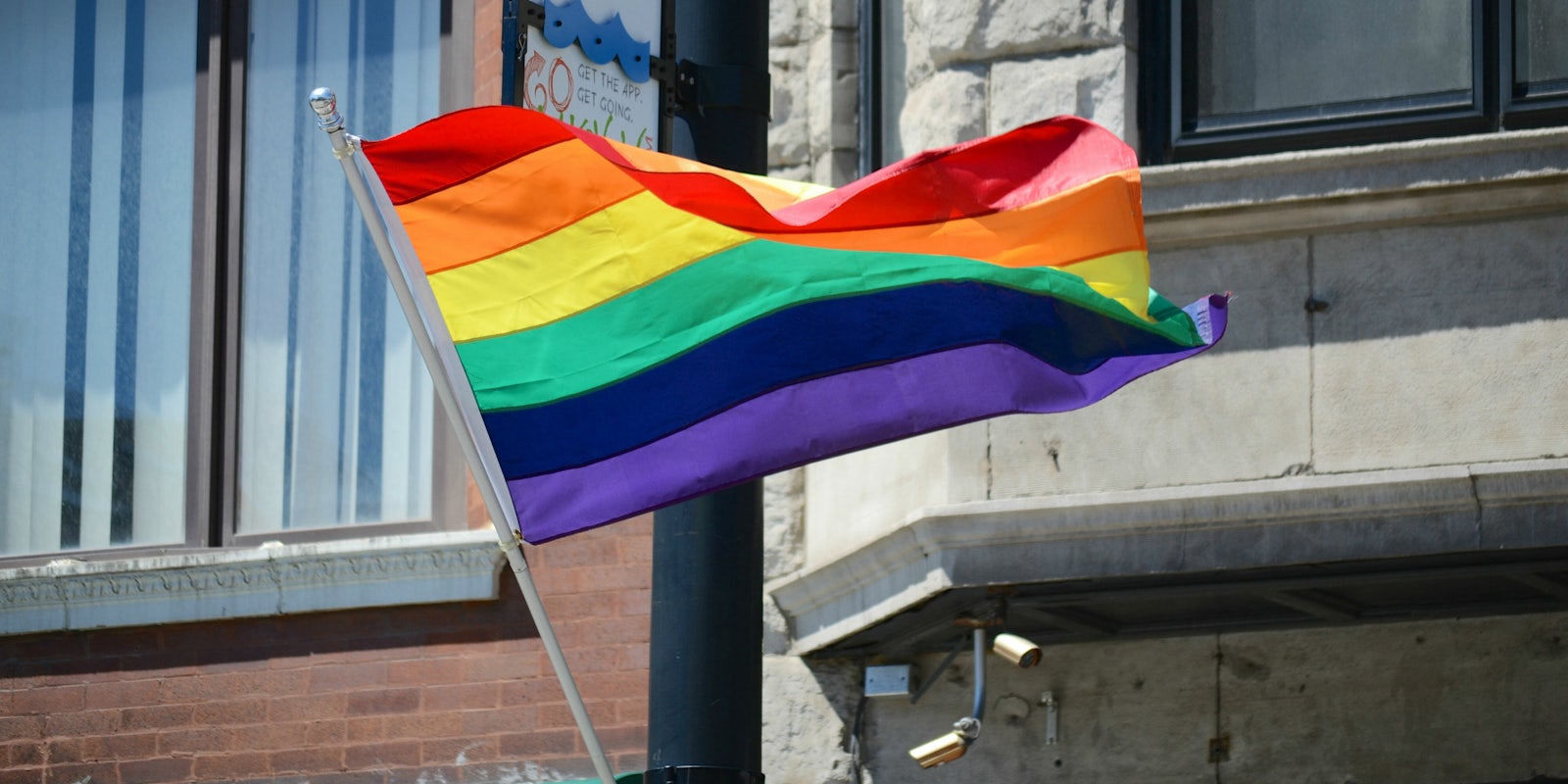 The rainbow flag represents the LGBTQ community.