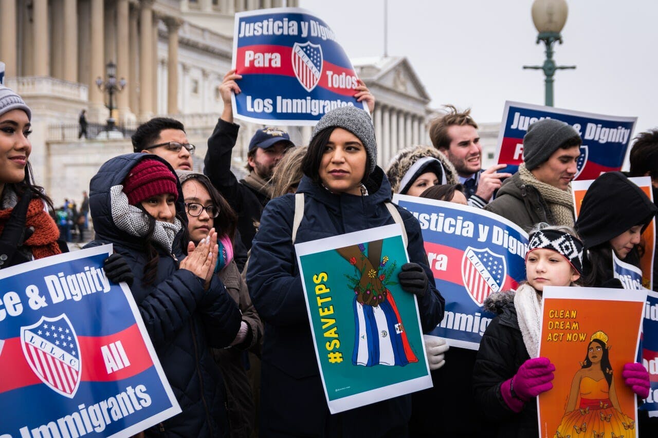 Yocelyn Riojas protests on the day of the Women's March holding one of her illustrations.