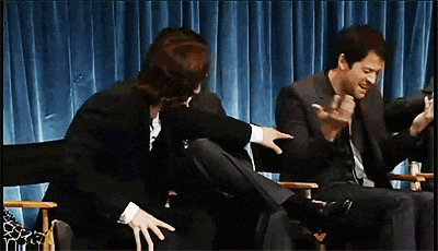 Gif of the cast of SPN reacting to something with uproarious laughter.