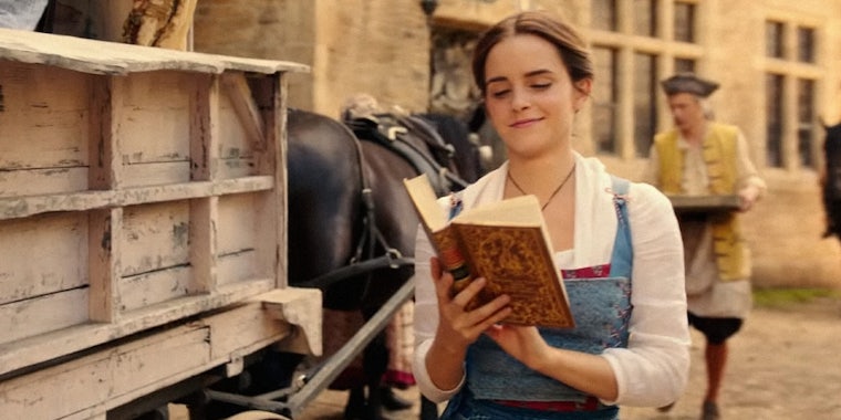 Belle reading a book while walking