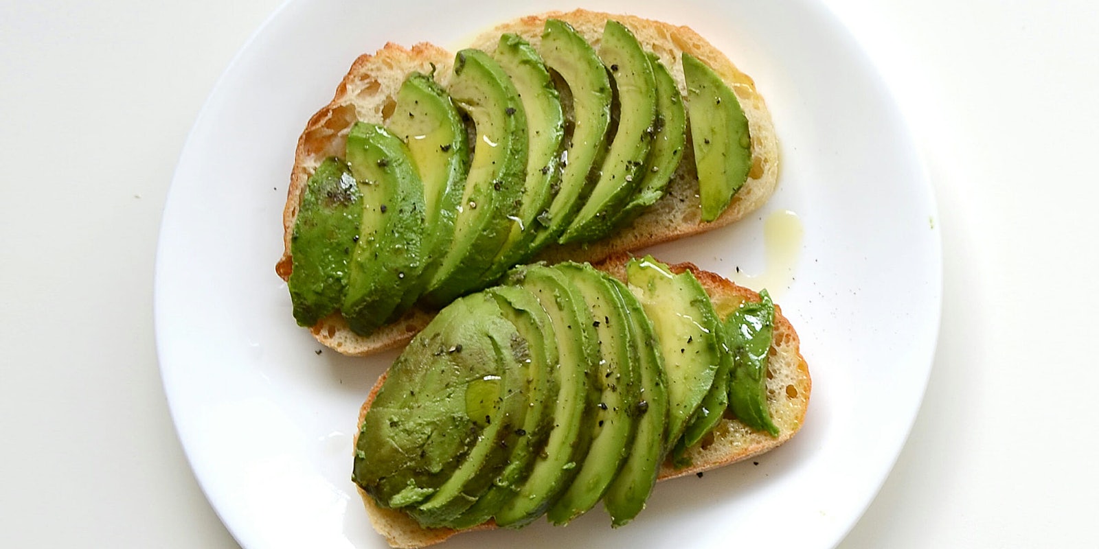 Sliced avocado on toasted bread