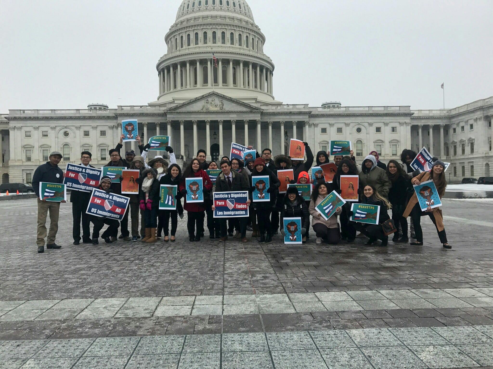 Yocelyn Riojas and other protest on the day of the Women's March holding her illustrations.