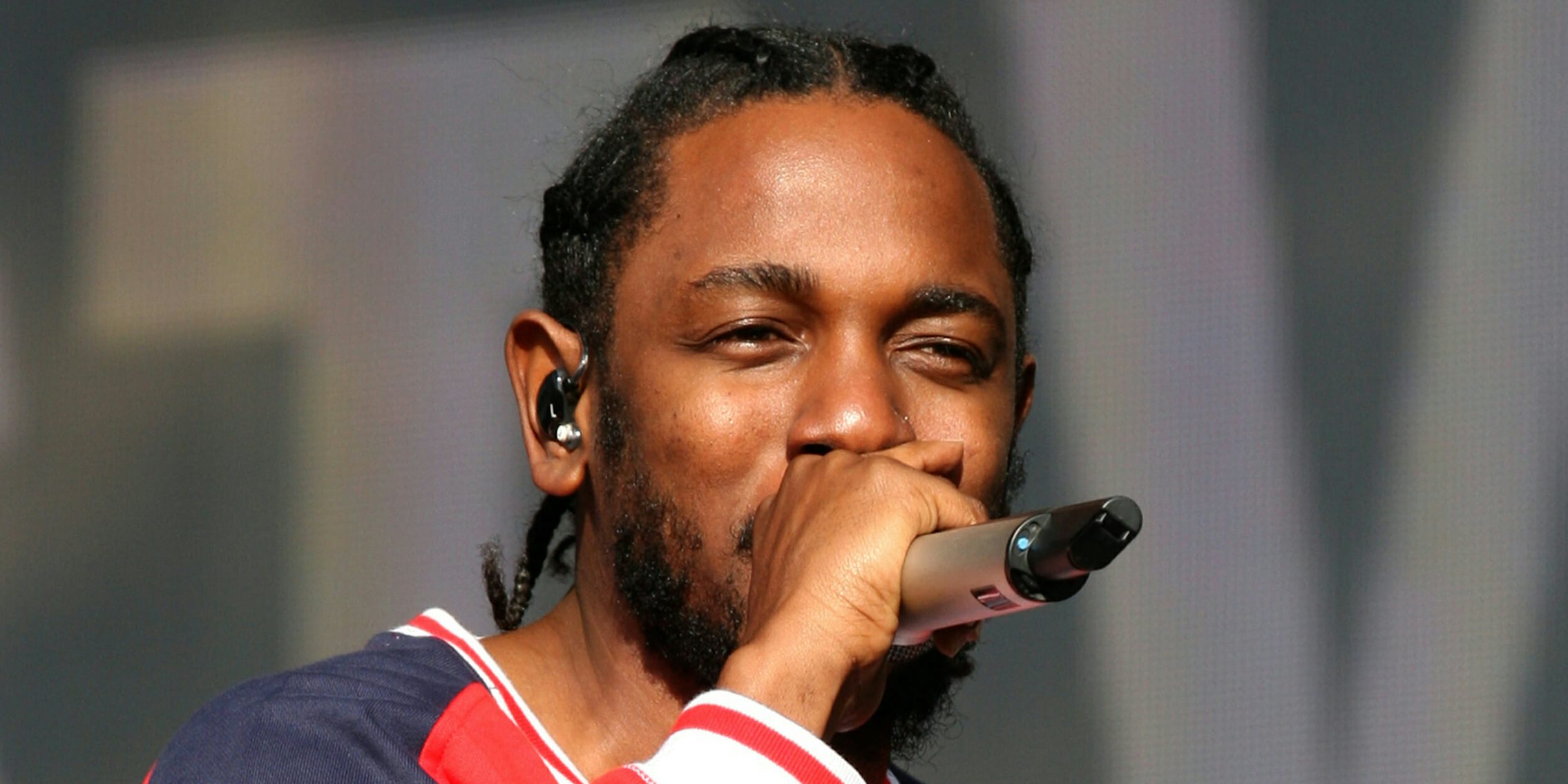 Kendrick Lamar on stage with a microphone, DAMN.