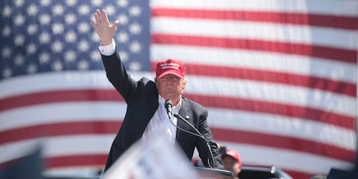 Donald Trump waving in front of American flag