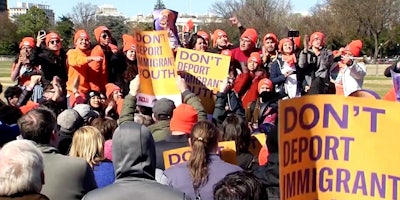 People rally at a DACA protest the day before Congress' March 5 deadline in front of the White House.