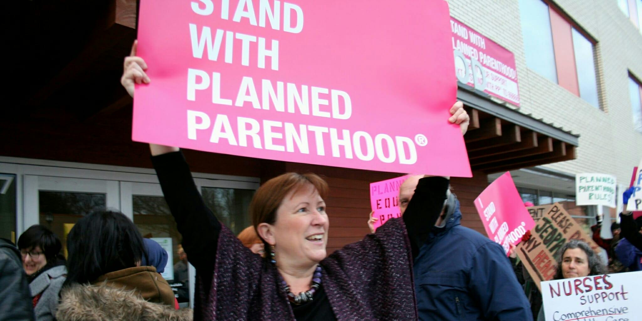 Planned Parenthood supporters protesting with signs.