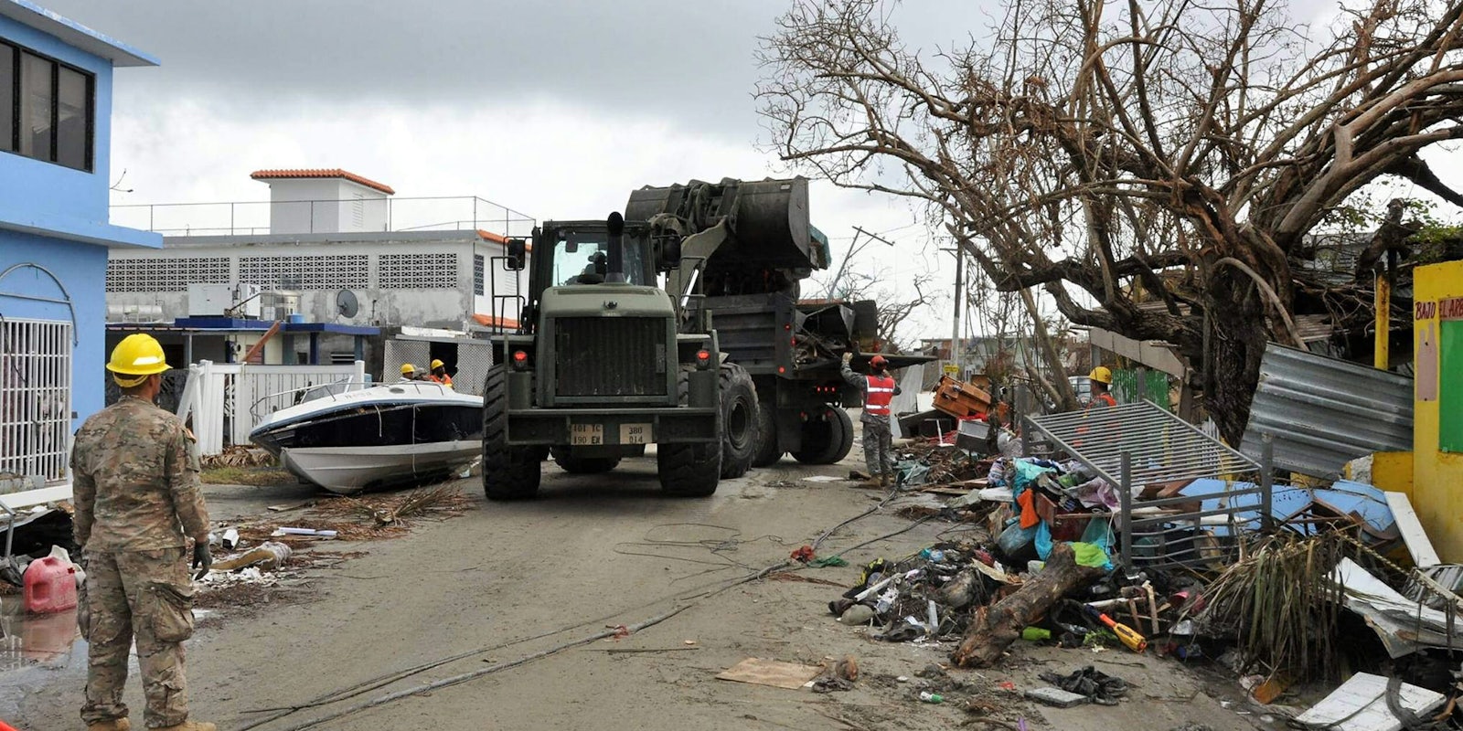 Puerto Rico National Guard Soldiers, along with volunteers of the Puerto Rico State Guard, work together to fulfill the road clearing mission at Punta Santiago in Humacao, PR, Sept. 27, 2017.