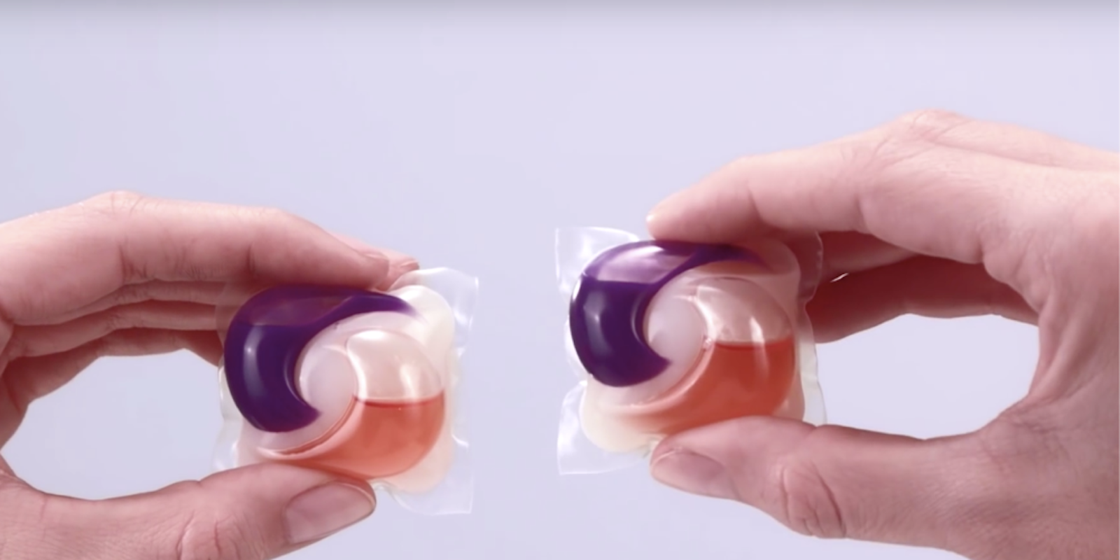 two tide pods in hands