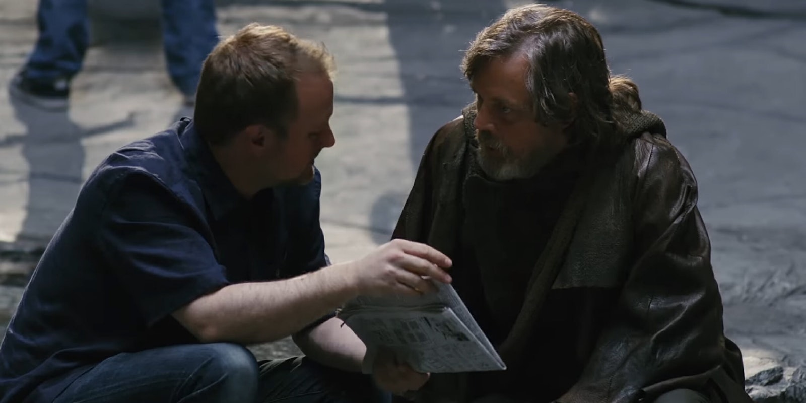 Director Rian Johnson talks to Mark Hamill on set