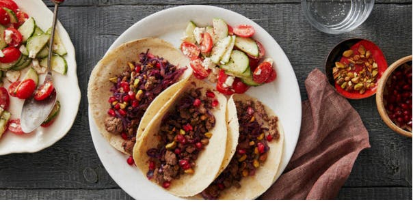 Greek lamb tacos with pomegranate seeds and cucumber-tomato salad