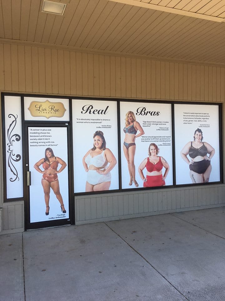 A body-positive window advertisement for Livi Rae Lingerie featuring diverse models.