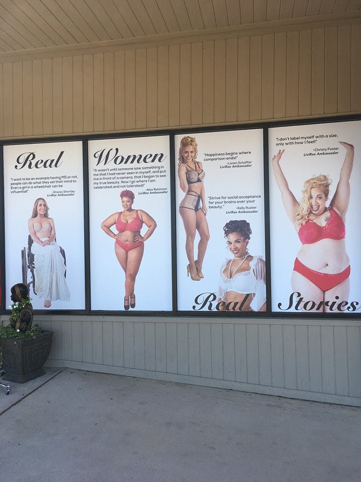 A body-positive window advertisement for Livi Rae Lingerie featuring diverse models.