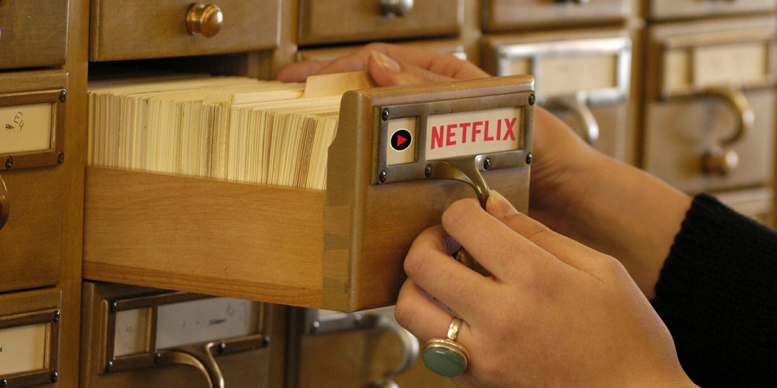 Woman opening card catalog with Netflix logo on the front
