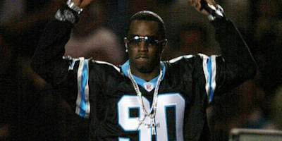 Diddy wearing a Panthers jersey.