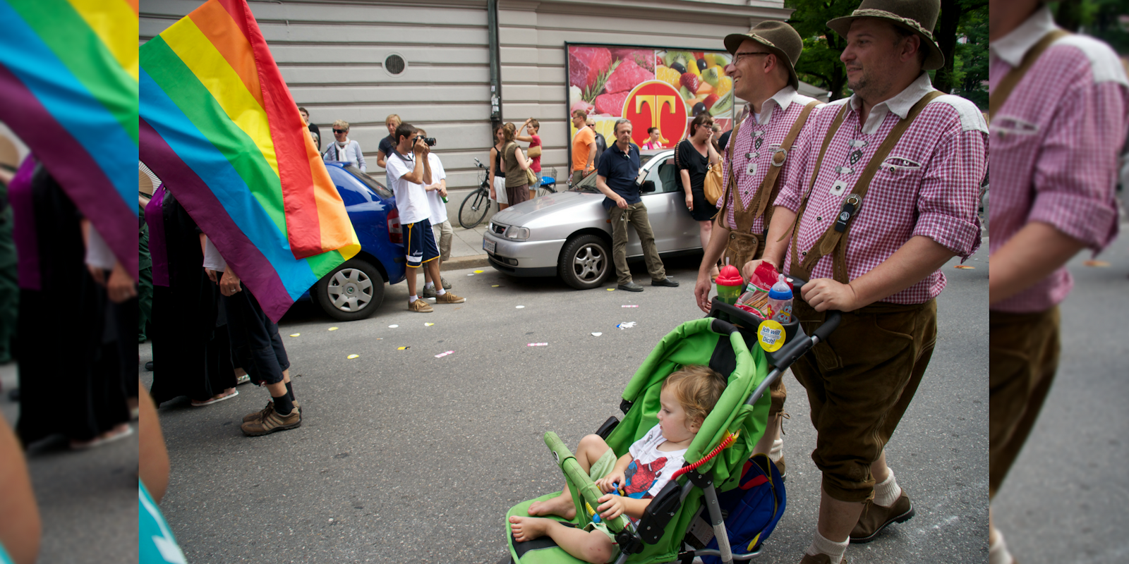 A gay couple and their child participate in a Pride parade in Munich
