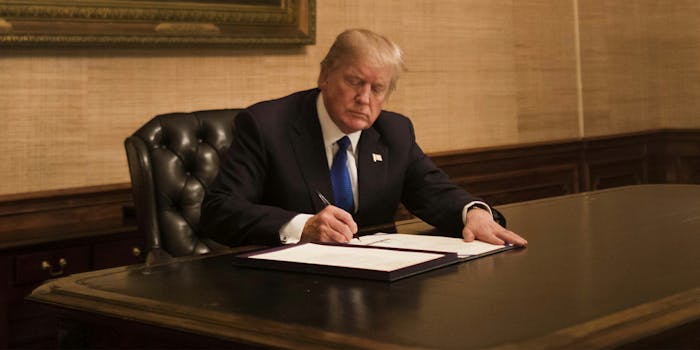 Trump signing bill at desk